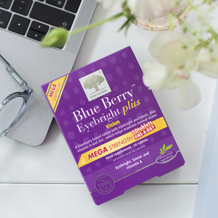 Product image of New Nordic Blue Berry™ Eyebright Plus package on a table next the a computer.