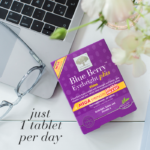Blue Berry™ Eyebright Plus displayed in an everyday setting with a computer and a pair of glasses with text Just 1 tablet per day.