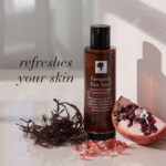 The Energising Face Toner™ shown with sea moss and fresh pomegranate with text Refreshes your skin.