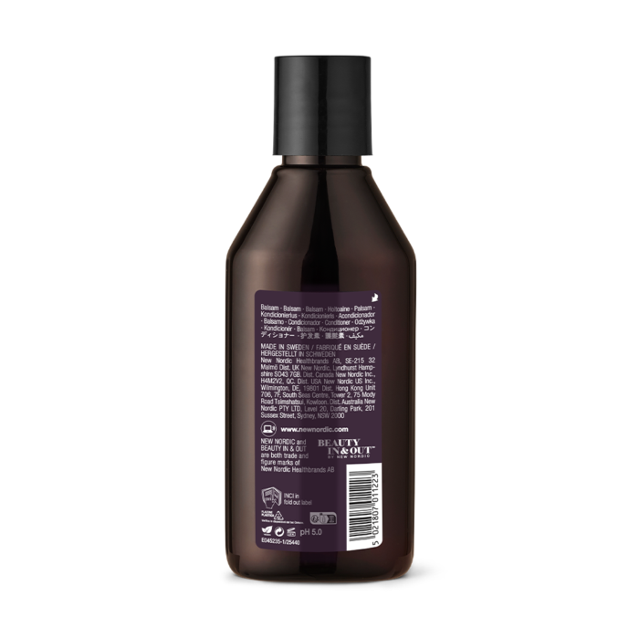 New Nordic Hair Volume™ Conditioner repairs and nourishes hair with apple, millet, and rice protein, adding volume, shine, and softness. Image of back of product.