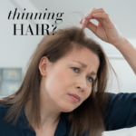 Woman checking her thinning hair in a mirror, looking insecure with text Thinning hair?
