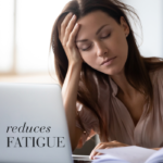 Tired woman closing her eyes and holding her head in front of a computer with text Reduced fatigue.