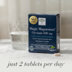 Magic Magnesium™ Glycinate 600 mg displayed with a glass of water and text Just 2 tablets per day.