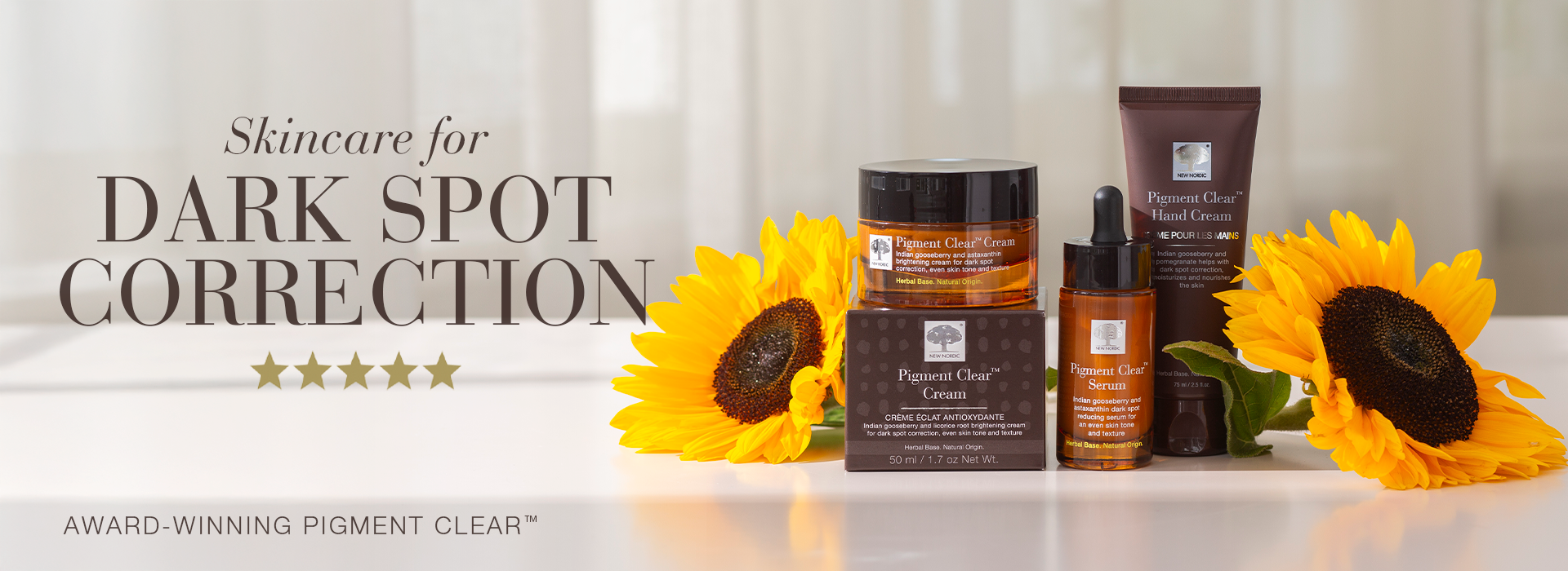 Banner showing Pigment Clear skincare products, including a face cream, serum, and hand cream, with sunflowers in the background and the text “Skincare for dark spot correction”.