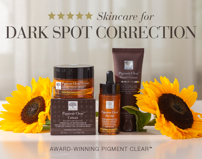Banner showing Pigment Clear skincare products, including a face cream, serum, and hand cream, with sunflowers in the background and the text “Skincare for dark spot correction”.
