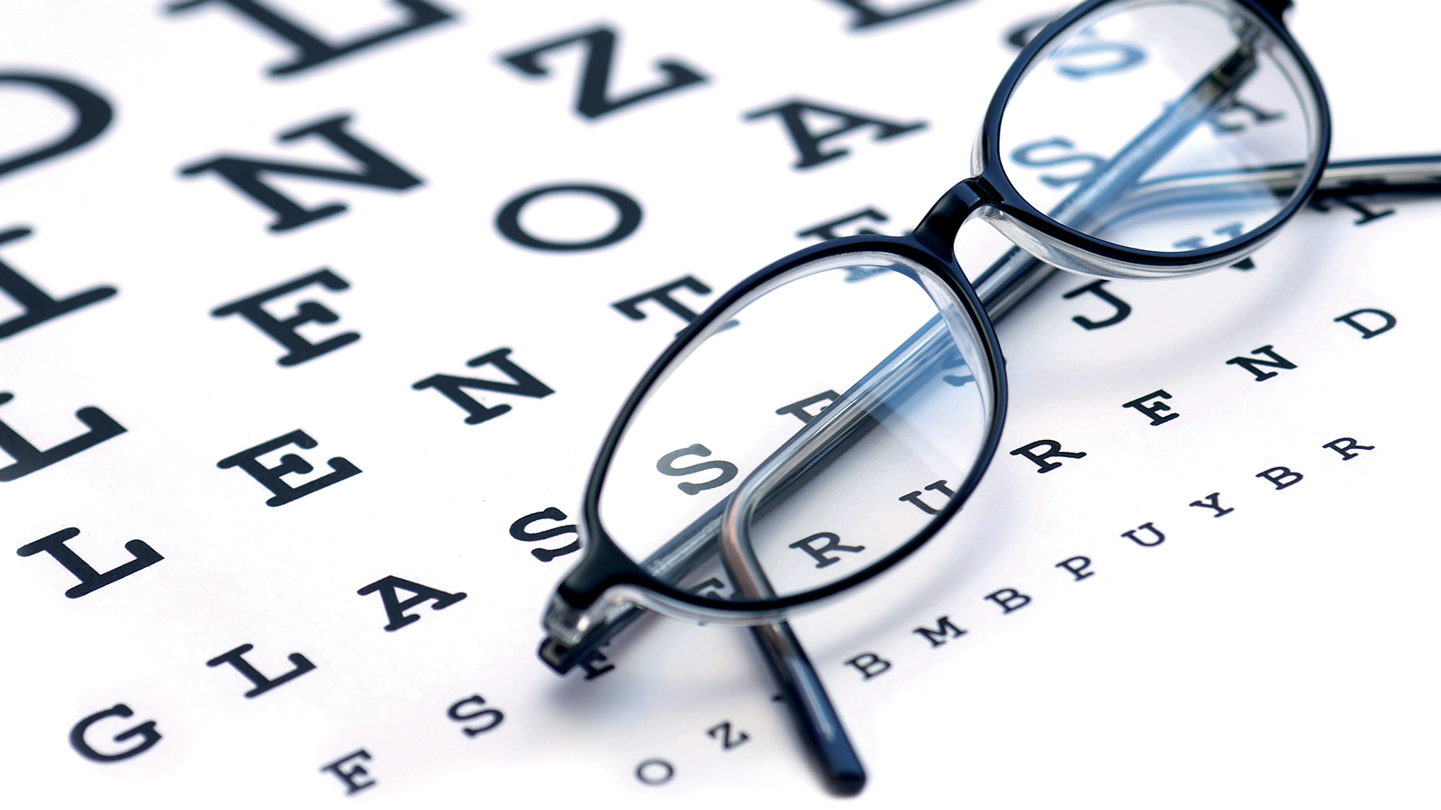 Blue Berry™ Eyebright Plus 20 Eyeglasses on eye chart background.