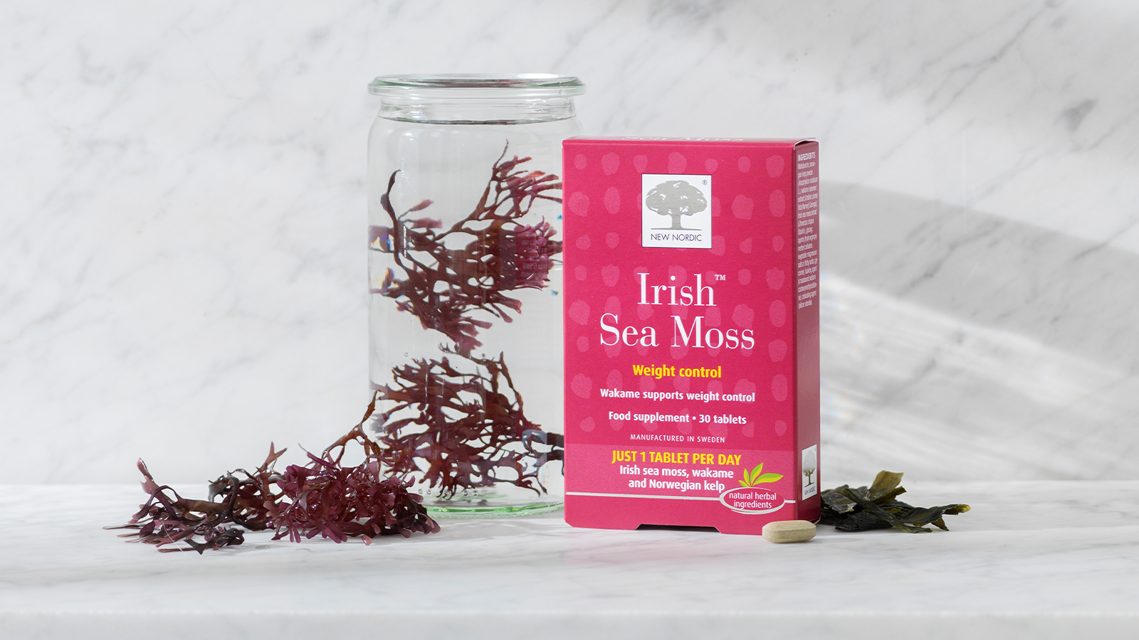Fat Burner™ 16 a box of Irish Sea Moss tablets next to a jar with water and irish sea moss in.
