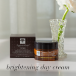 The Pigment Clear™ Cream displayed with a flower and the text Brightening day cream.
