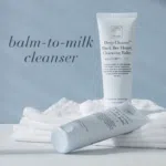 Light blue tube of Deep Cleanse™ Black Bee Honey Cleansing Balm with text Balm-to-milk cleanser