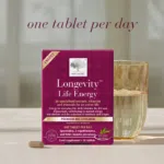The Longevity™ Life Energy package displayed with a tablet and a glass of water.