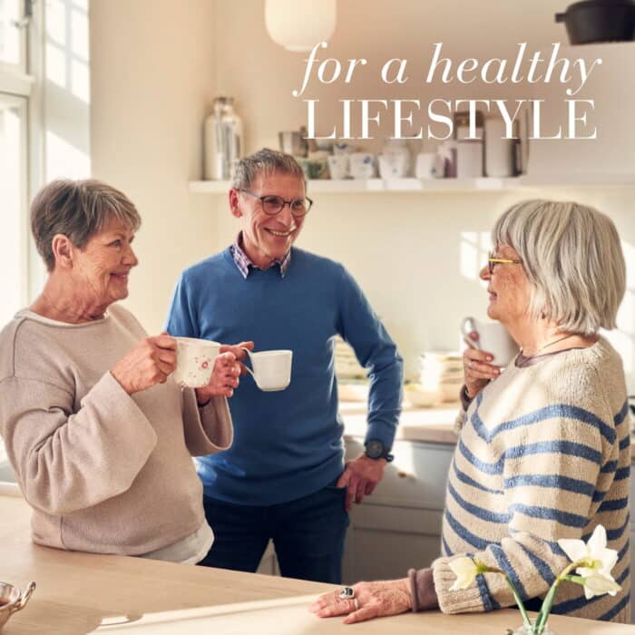 Three older people drinking tea, having a conversation, promoting the feeling of Longevity and living healthier