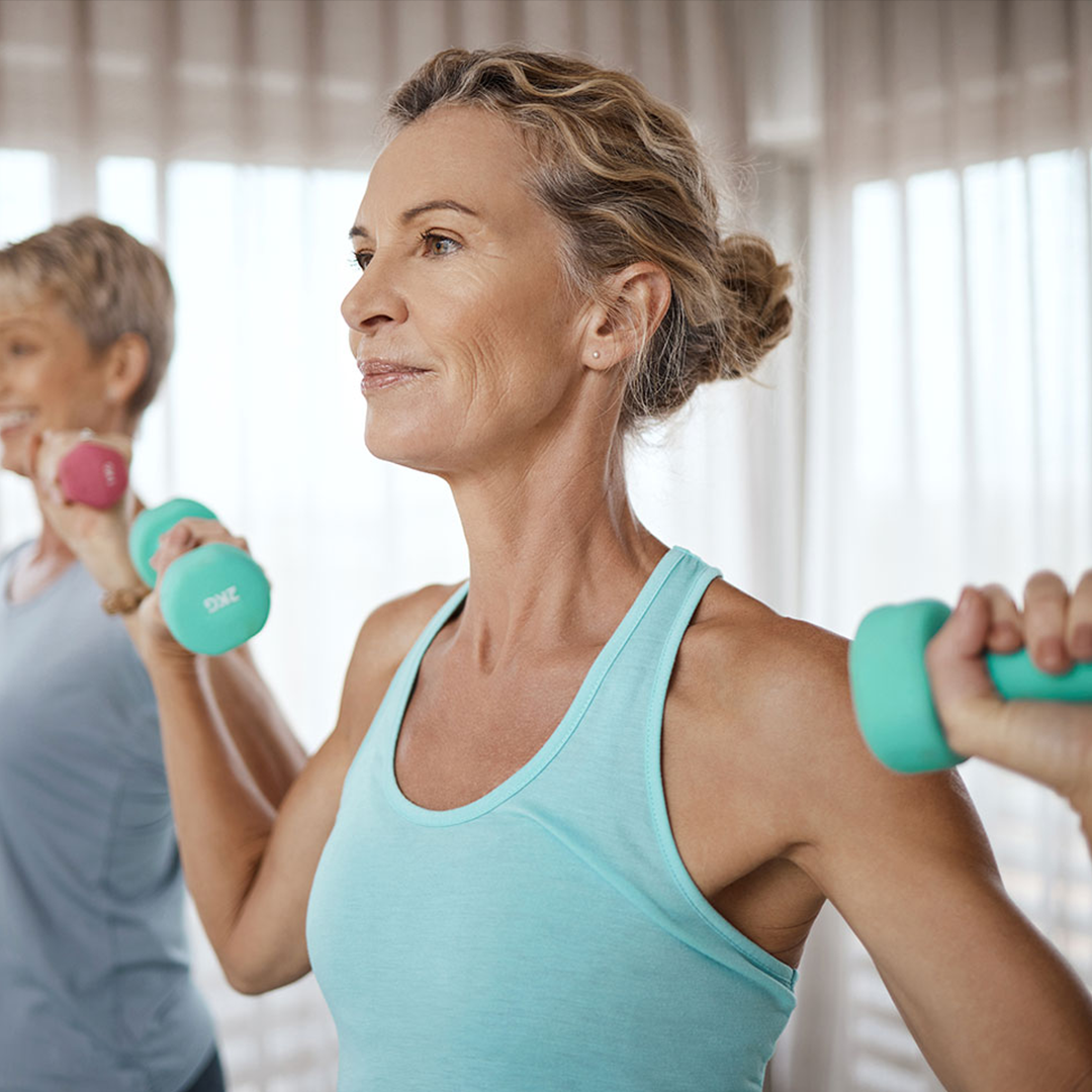 Image of an older woman taking part in a weight training class