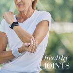Woman stretching her arm outdoors, highlighting joint mobility and an active, healthy lifestyle.