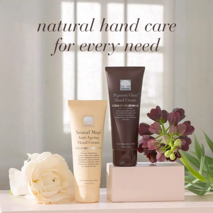 New Nordic Natural Magic™ Anti-Ageing Hand Cream and Pigment Clear™ Hand Cream displayed with flowers.