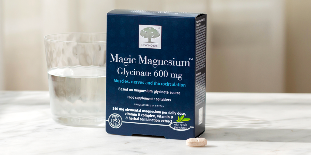 Magic Magnesium Glycinate Box with a glass of water to the left