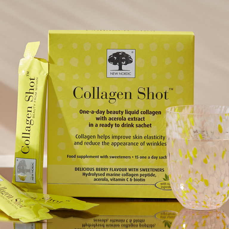 Pack of Collagen Shot on a table with a water glass