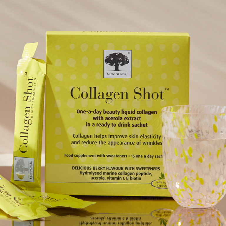 Box of Collagen Shot with a glass next to it and two sachets leaning against the side.