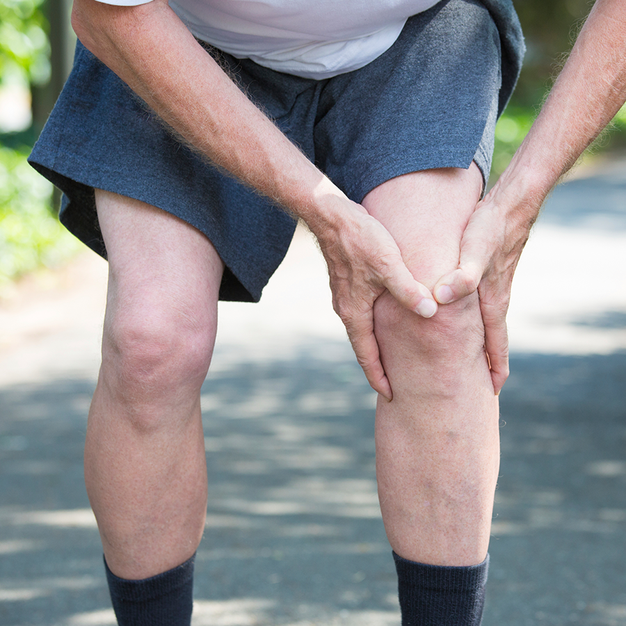 Man holding his leg and knee in pain