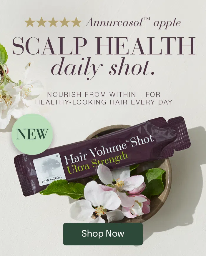 Hair Volume Shot Ultra Strength Sachet laying on some flowers with the text Annurcasol™ apple SCALP HEALTH daily shot. NOURISH FROM WITHIN - FOR HEALTHY-LOOKING HAIR EVERY DAY next to it