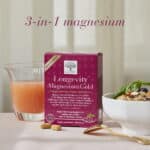 New Nordic Longevity Magnesium Gold™ with a glass of juice, breakfast bowl and tablets, featuring 3-in-1 magnesium.